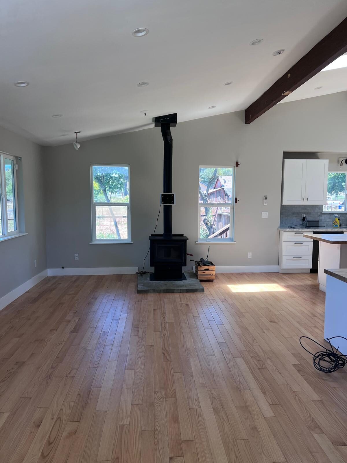 Home A — open living area with wood-burning stove