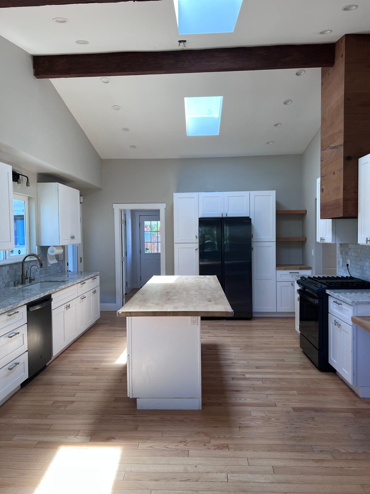 Home A — chef's kitchen with island and skylights