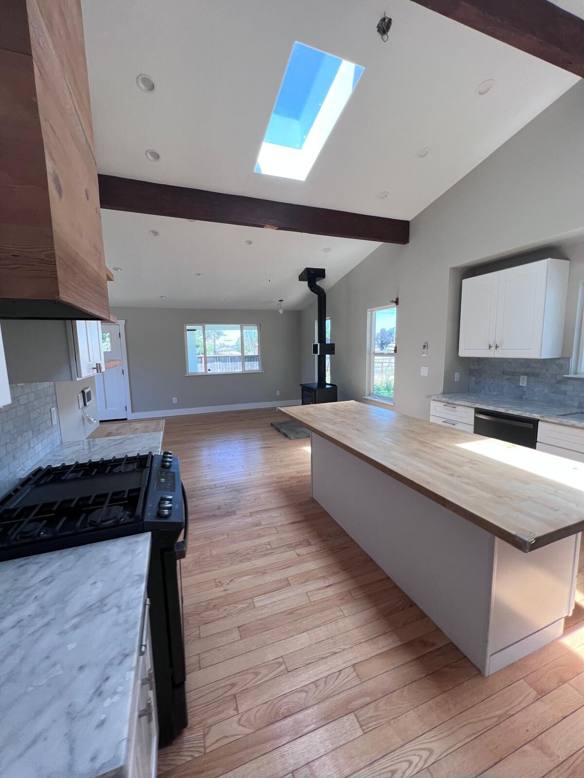 Home A — kitchen opening to living room with skylight