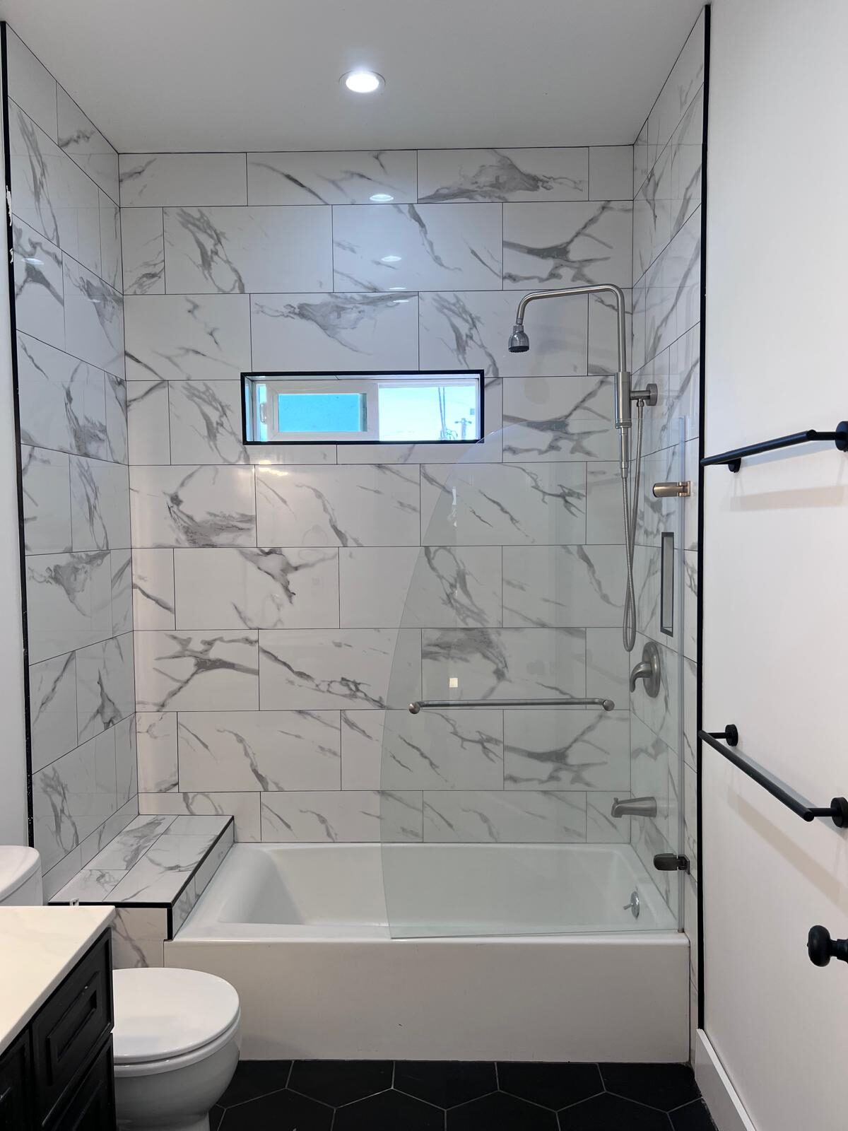 Home A — marble-tiled bathroom with soaking tub and shower
