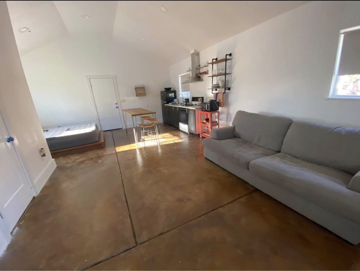 Studio B — open living space with kitchenette and vaulted ceilings