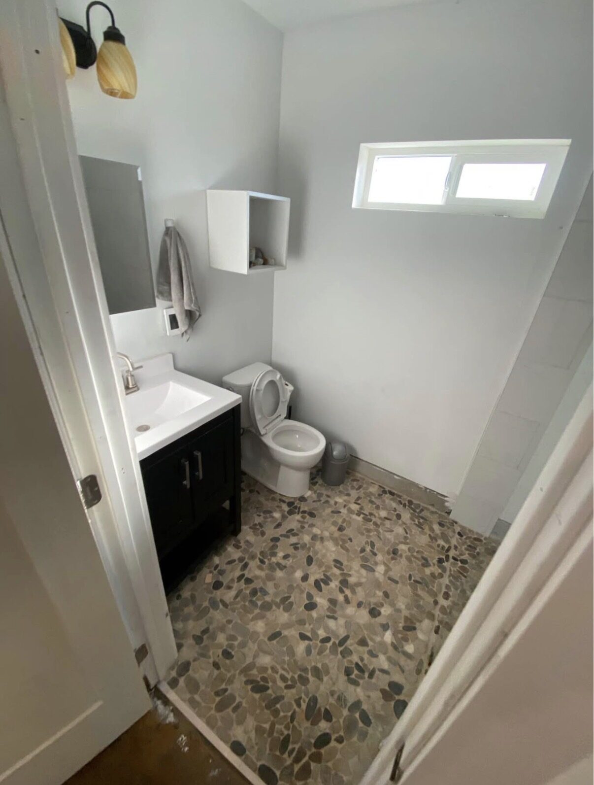 Studio B — bathroom with pebble tile floor