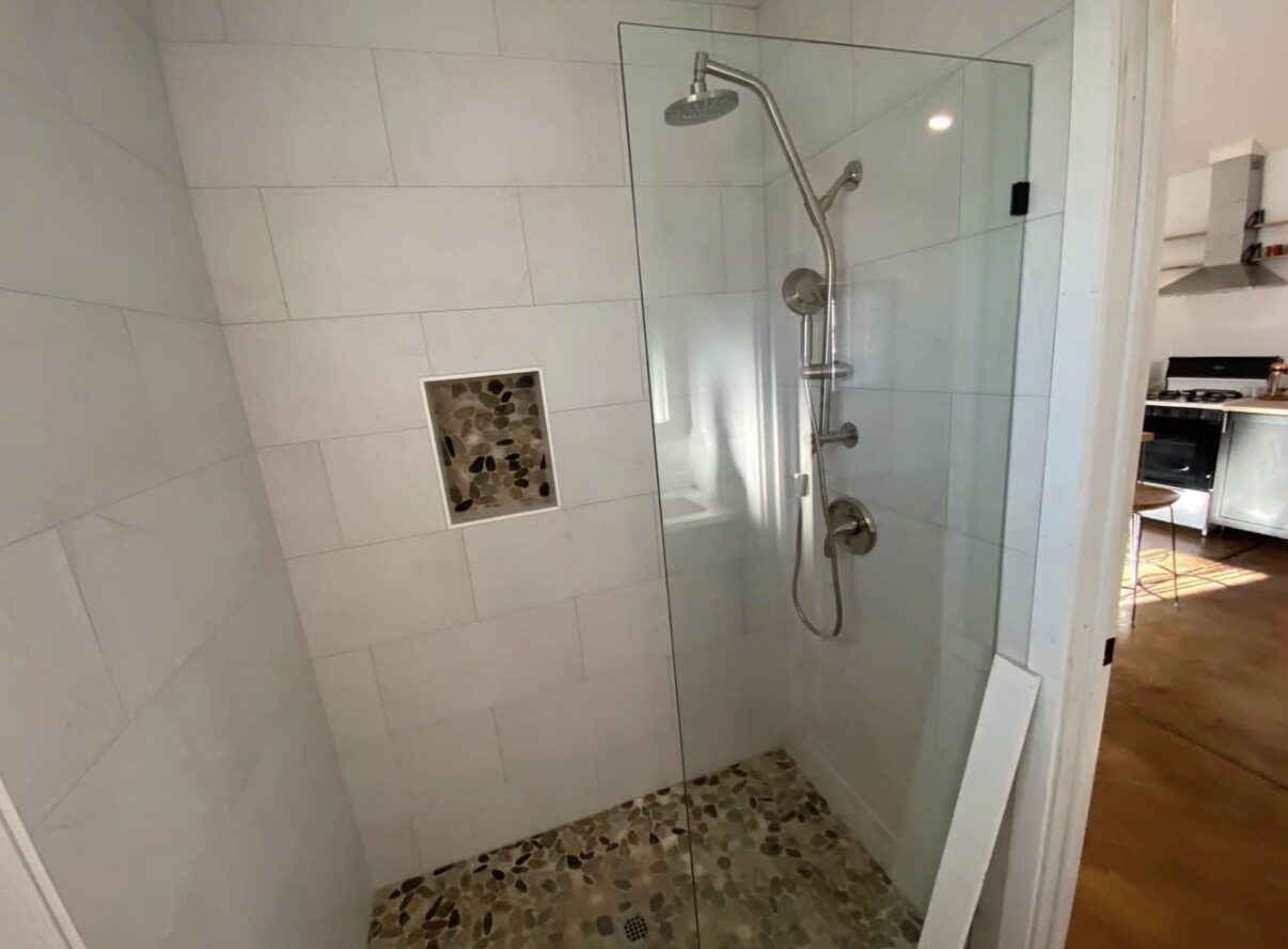 Studio B — walk-in glass shower with rain showerhead