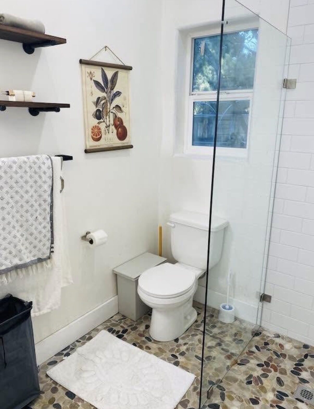 Studio C — walk-in glass shower with pebble tile floor