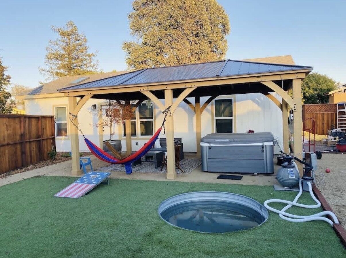 Backyard with covered pergola, spa, and cold plunge