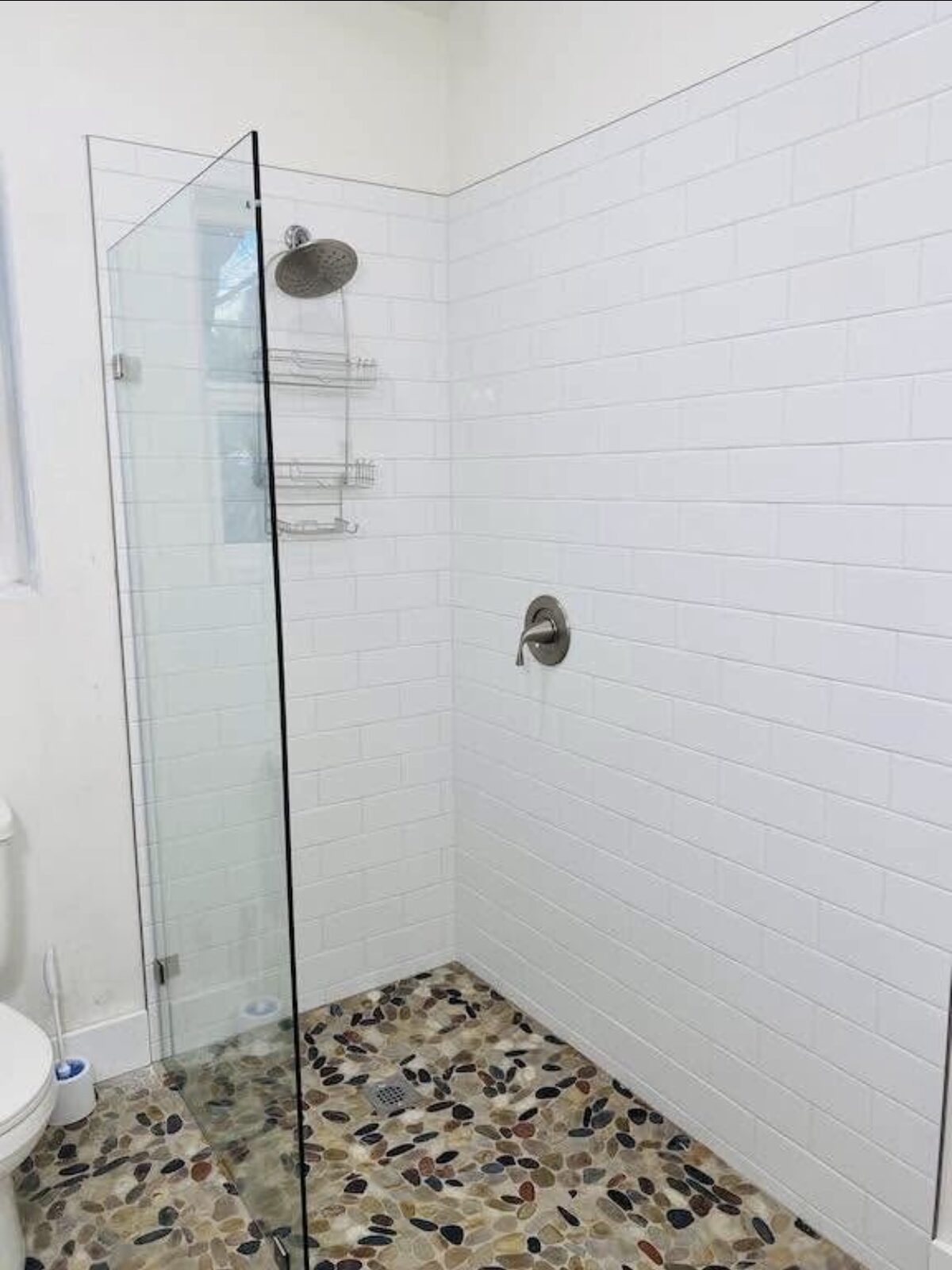 Walk-in shower with pebble floor